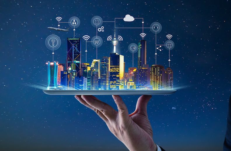 Waiter hand holding an empty digital tablet with Smart city with smart services and icons, internet of things, networks and augmented reality concept , night scene .