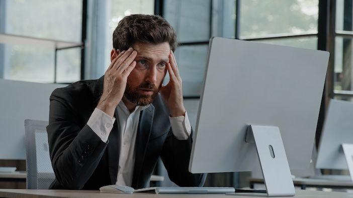 Caucasian bearded 40s middle-aged businessman worker employee man typing laptop feel failure upset with lost of information online error stressed look at computer screen suffer from headache pressure.