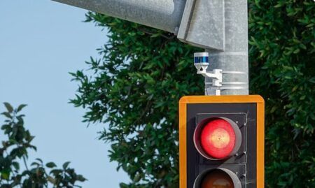 Blue Ouster lidar installed on a signalized intersection.