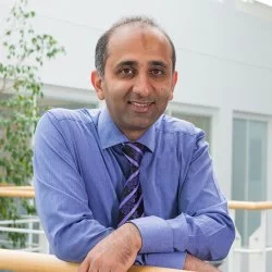 Asian man in blue shirt and tie