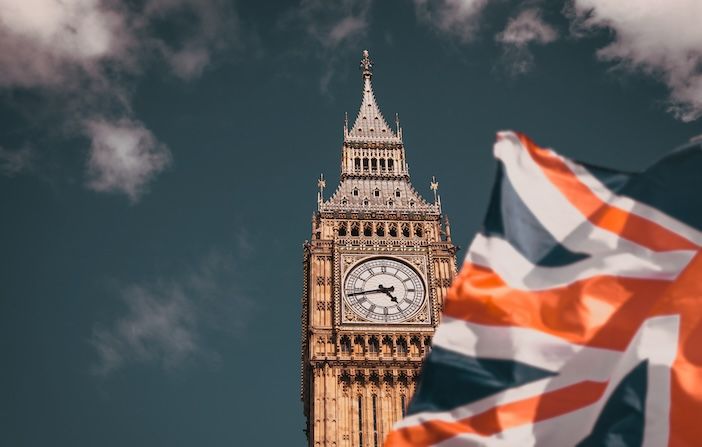flag of UK waving in front of Big Ben London UK