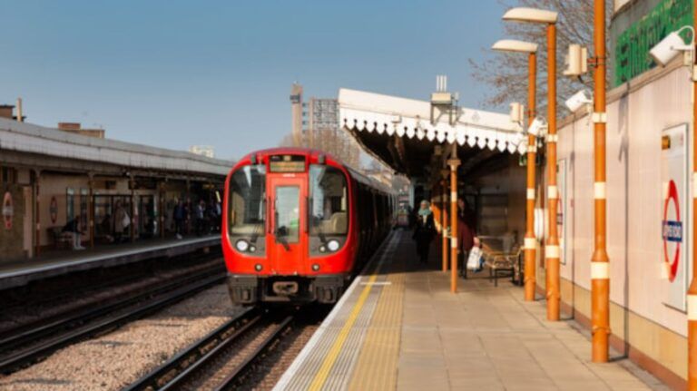 A London Underground train at an open-air station