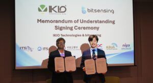 A picture of IKIO and bitsensing signing the MoU