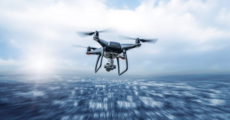 Modern dark drone in flight over the city