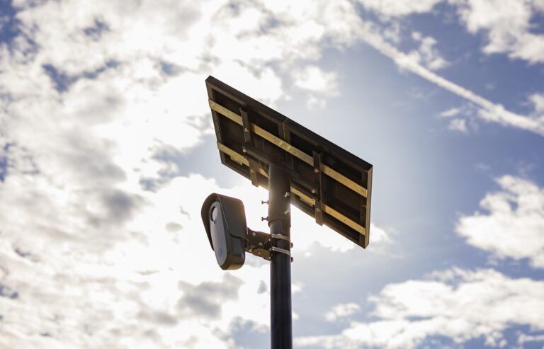 Picture of a Flock Safety LPR camera on a pole