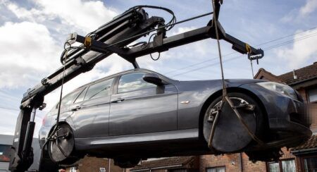 Car being loaded onto a flatbed truck