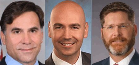 From left to right: Paul Roberti, PHMSA Administrator, wearing a dark suit with blue shirt and dark tie; Jonathan Morrison, NHTSA Administrator, wearing a dark suit jacket with white shirt; and Sean McMaster, FHWA Administrator, wearing a dark suit with white shirt and red patterned tie, and glasses