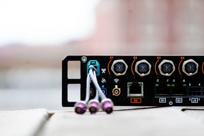  Close-up view of Vehicle Gateway's connectivity panel featuring ethernet ports, antenna connections, and multiple circular diagnostic connectors with LED status indicators