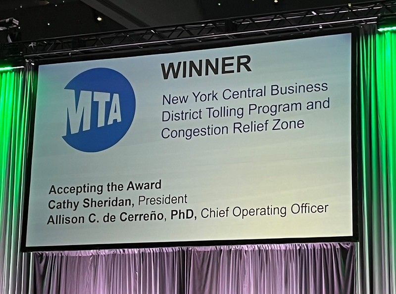 Screen on stage reads "WINNER New York Central Business District Tolling Program and the Congestion Relief Zone