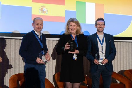 Double award for Valerann proves data fusion has come of age in ITS Business woman collects award on stage flanked by two businessmen