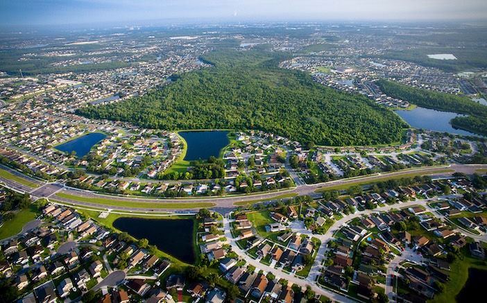 Florida county tackles Disney-area traffic with real-time work zone platform Drone view of urban area with roads and large park areas