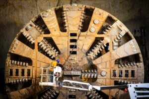 Workers inspect and repair a Tunnel boring machine (TBM) (often called a "mole") used to excavate subway tunnels.