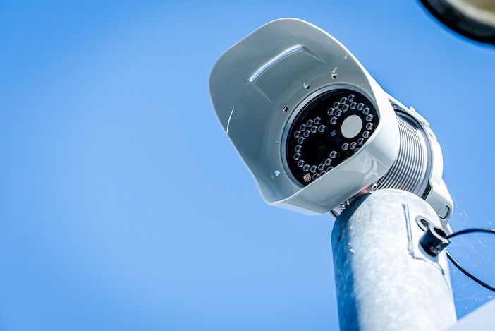 A traffic camera against a blue sky