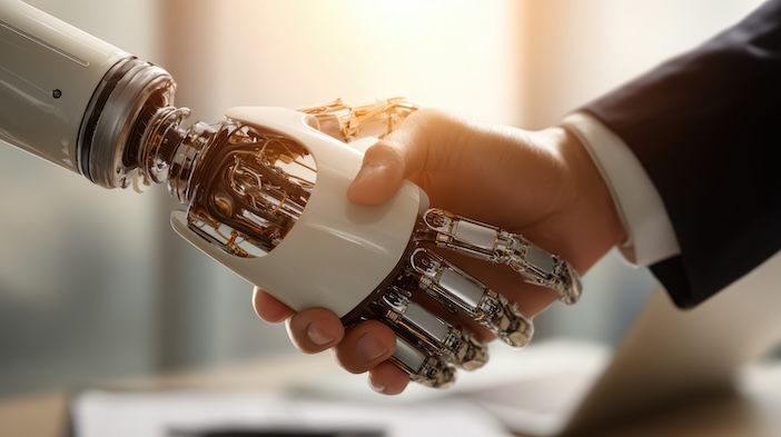 Close-up of a robotic mechanical hand shaking hands with a human hand in a business suit, set against a softly lit office background.