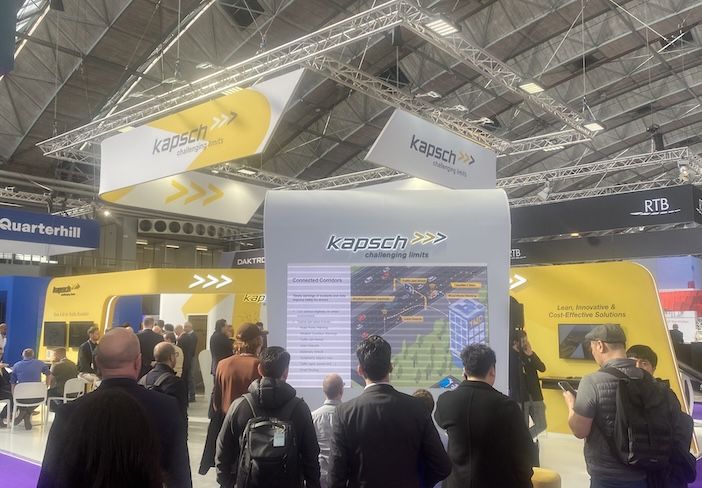 a crowded expo stand with yellow kapsh branding