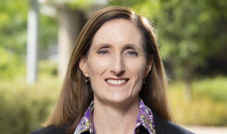 Professional headshot of Susan Harris, chief executive of ITS Australia, smiling outdoors against a soft green background.