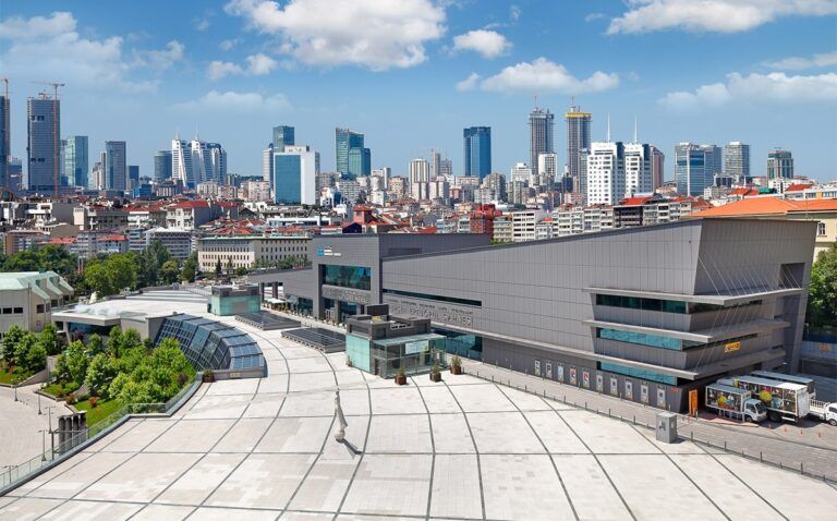 Daytime aerial view of the Istanbul Congress Center and surrounding plaza with the Istanbul city skyline in the background
