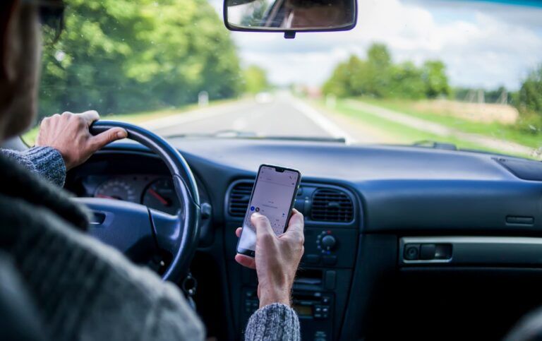Picture of a man on a phone while driving