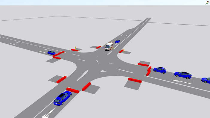 PTV Vissim 3D simulation view of a four-way urban intersection with cars and a van approaching from multiple directions and red detection zones marked on each approach.