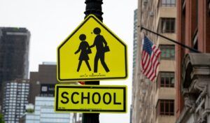 School Crosswalk Ahead Traffic Sign in a Road in New York