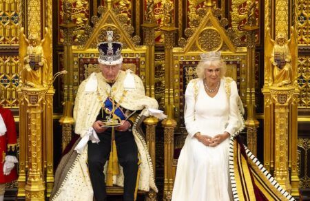 King’s Speech sets out UK transport legislation agenda for new parliamentary session King Charles III, wearing the Imperial State Crown and ermine-trimmed ceremonial robes, seated on a gold throne in the House of Lords chamber alongside Queen Camilla, who is dressed in white with a tiara and ermine-trimmed robe.