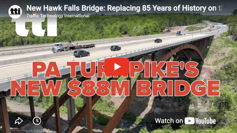 A YouTube video embed showing an aerial view of a highway bridge spanning a wooded gorge, with a red text overlay reading "PA Turnpike's New $88M Bridge" and a play button in the centre