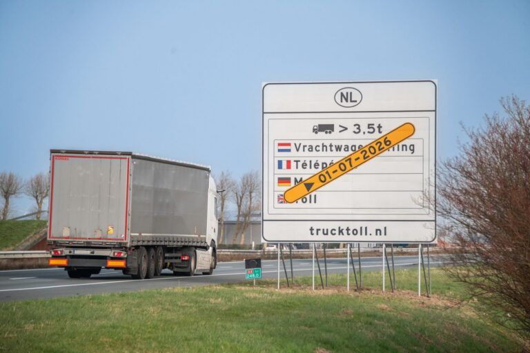 A truck passes a sign indicating the truck toll in the Netherlands