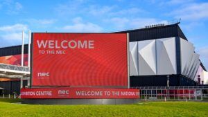 "Welcome to the NEC" on a giant LED screen outside the entrance to the Birmingham National Exhibition Centre