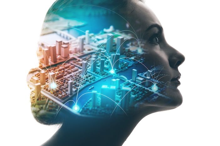 A double-exposure image showing the silhouette of a woman's head in profile, overlaid with an aerial view of a city model and glowing network connection points