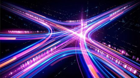 Traffic congestion could be tackled using fluid mechanics model This vibrant digital illustration features overlapping light streams in blue, pink, and orange, symbolizing high-speed data flow.