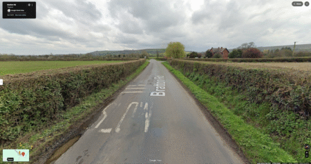 Connected vehicle data uncovers Wiltshire junction hazard Google Street View image of Bratton Road near Westbury, Wiltshire, in March 2024, showing hedges trimmed back from the carriageway with a clear sightline towards the junction
