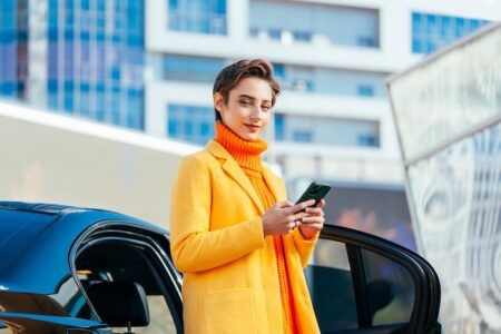 Nayax to acquire smart parking firm IPS Group Beautiful young woman with short hair driving car in the city - Pretty caucasian female adult business woman wearing elegant suit going to work in the office