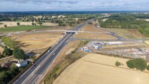 Aerial view of the new A47 dual carriageway and junction near Blofield, Norfolk, showing the completed road running through surrounding farmland