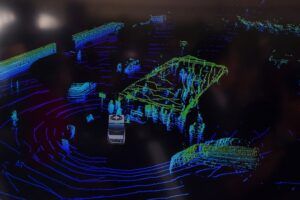 A lidar point cloud of an busy intersection with vehicles and pedestrians identifiable