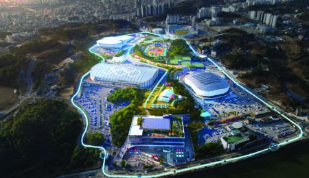 ITSWC KOREA: Preview of UK-Europe pavilion technologies and exhibitors Aerial view of a sports venue complex with several large arena buildings, car parks and greenery, overlaid with a glowing blue winding path connecting the buildings
