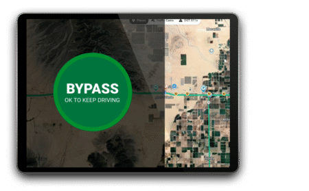 PrePass Bypass app expands to Oregon weigh stations A tablet mounted in a truck cab displaying the PrePass Bypass Mobile App with a green bypass confirmation screen