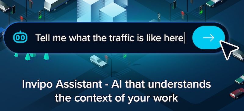 Illustration of a city intersection at night with cars and traffic lights, overlaid with a chat bar reading "Tell me what the traffic is like here" and the words